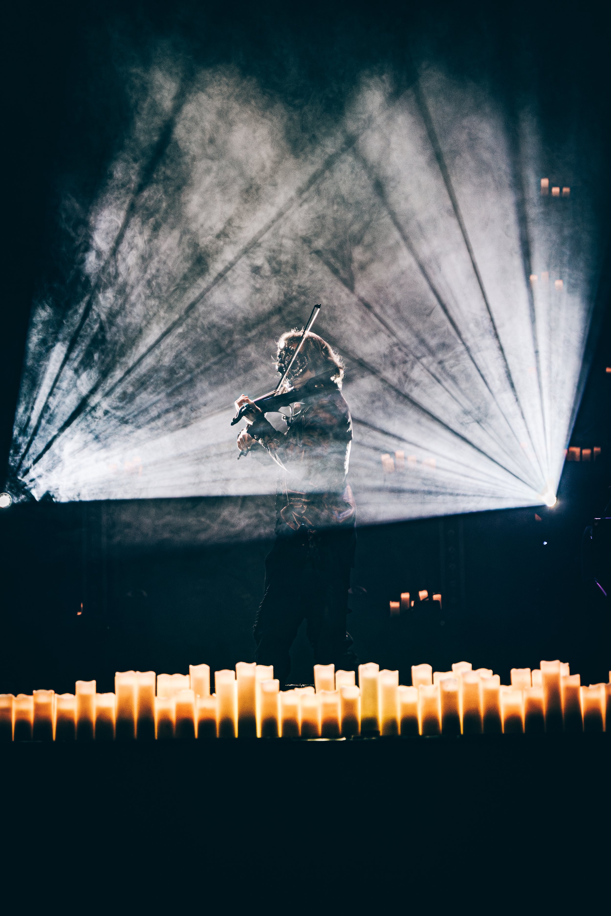 Performer on stage with dramatic lighting design